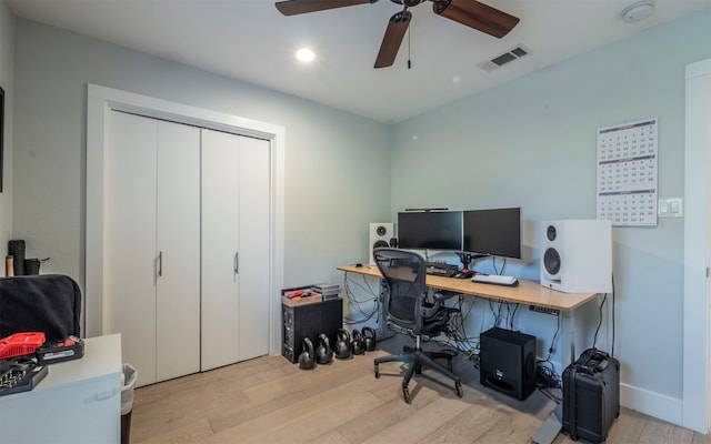 home office featuring ceiling fan and light hardwood / wood-style flooring