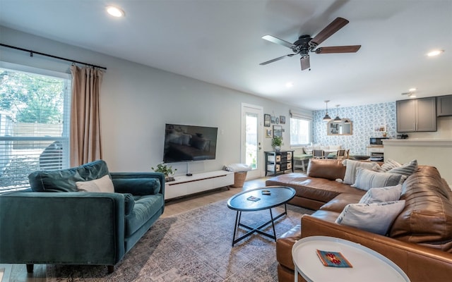 living room with wood-type flooring and ceiling fan