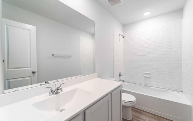 721 Barbary Coast Ln, Jarrell, TX 76537 - full bathroom featuring wood finished floors, toilet, vanity, and shower / bathtub combination