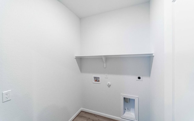 clothes washing area featuring electric dryer hookup, gas dryer hookup, hookup for a washing machine, and hardwood / wood-style flooring