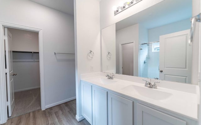 bathroom with a shower, vanity, and hardwood / wood-style flooring