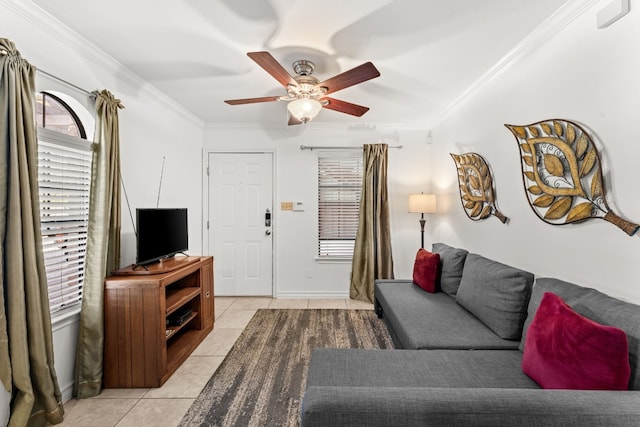 tiled living room with ceiling fan and crown molding