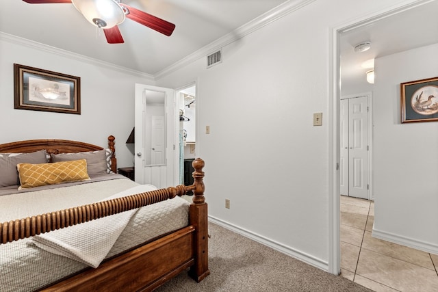 bedroom with ceiling fan, crown molding, and light carpet