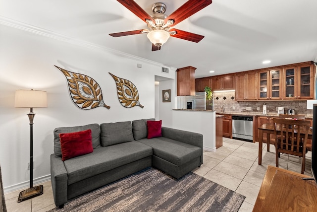 living room featuring ceiling fan, light tile patterned flooring, sink, and crown molding