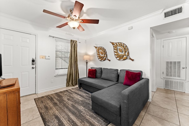 living room featuring light tile patterned floors, ceiling fan, and crown molding