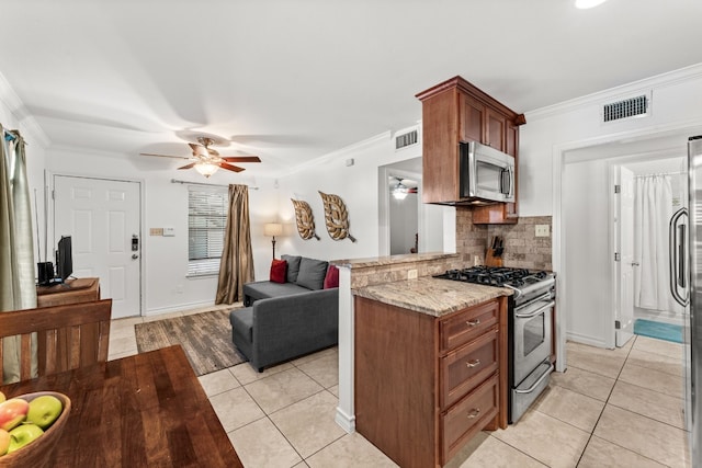 kitchen featuring decorative backsplash, kitchen peninsula, stainless steel appliances, crown molding, and light tile patterned flooring