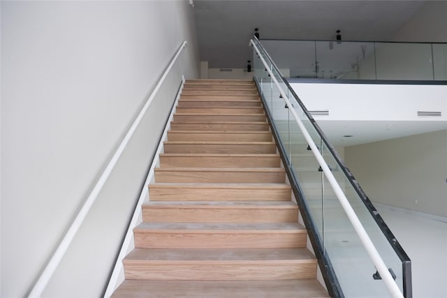 stairway featuring wood-type flooring