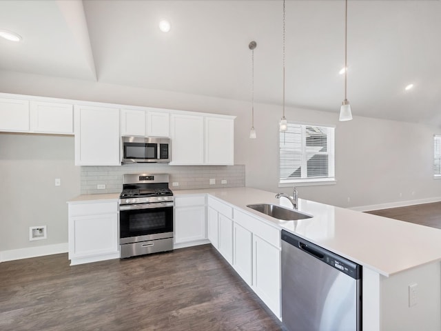 kitchen featuring decorative light fixtures, stainless steel appliances, white cabinetry, and sink