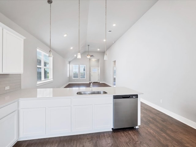 kitchen featuring dishwasher, sink, dark wood-type flooring, lofted ceiling, and white cabinets