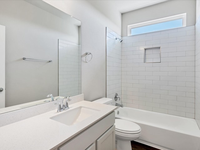 full bathroom featuring tiled shower / bath combo, toilet, wood-type flooring, and vanity