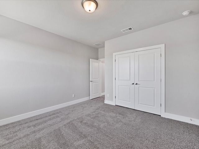 unfurnished bedroom with carpet and a closet