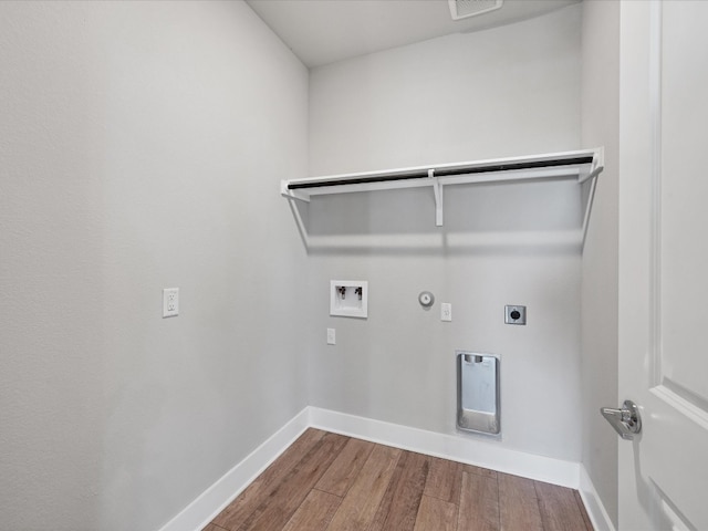 laundry area with hardwood / wood-style floors, electric dryer hookup, hookup for a gas dryer, and washer hookup