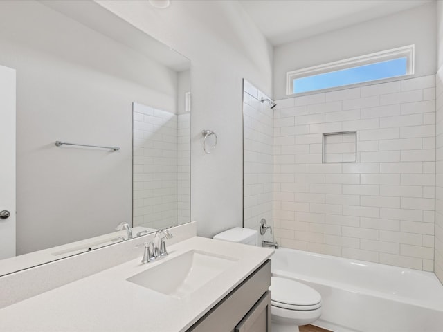 full bathroom with vanity, toilet, and tiled shower / bath combo