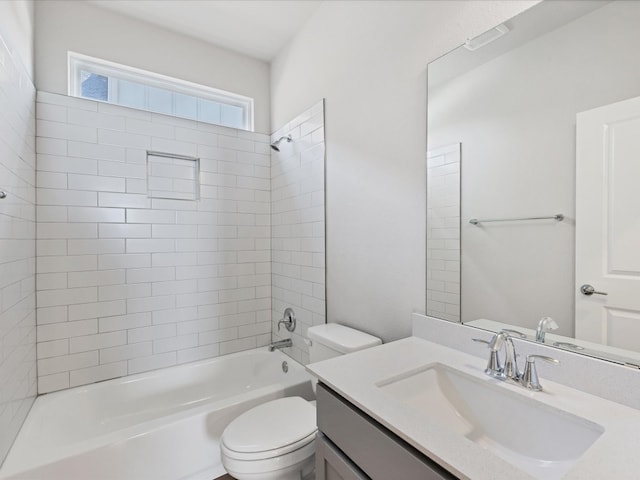 full bathroom with vanity, toilet, and tiled shower / bath