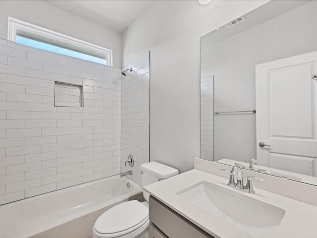 full bathroom with vanity, toilet, and tiled shower / bath