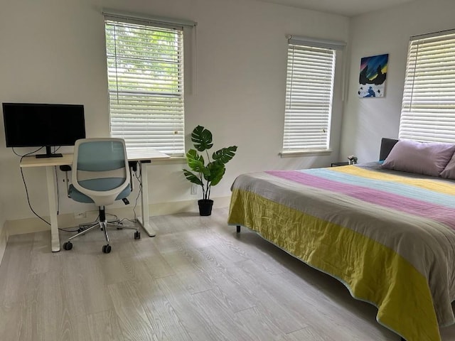 bedroom with light wood-type flooring