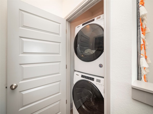 laundry area featuring stacked washing maching and dryer