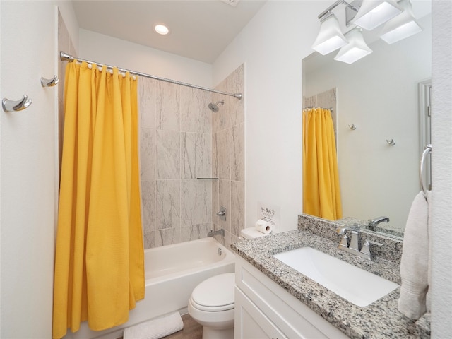 full bathroom with vanity, shower / bath combo, and toilet