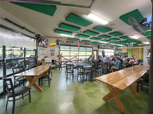 dining space featuring concrete flooring and plenty of natural light