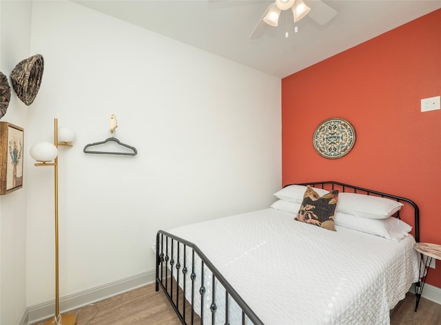 bedroom featuring wood-type flooring and ceiling fan