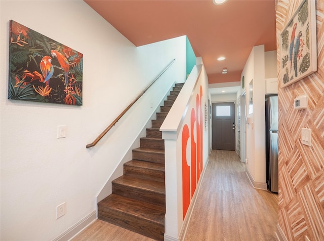 staircase with wood-type flooring