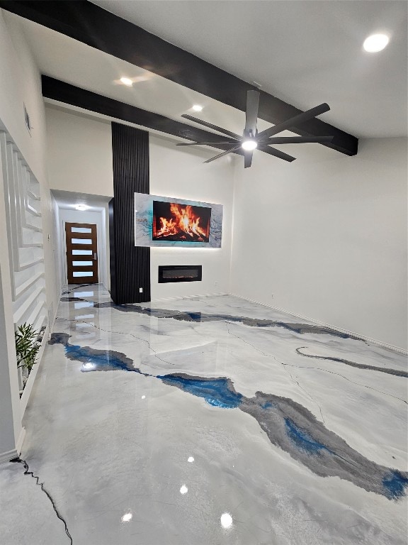 unfurnished living room with ceiling fan and beamed ceiling