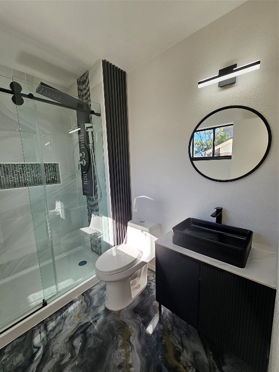 bathroom featuring walk in shower, vanity, and toilet