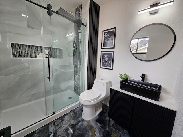 full bathroom with toilet, marble finish floor, a shower stall, and vanity