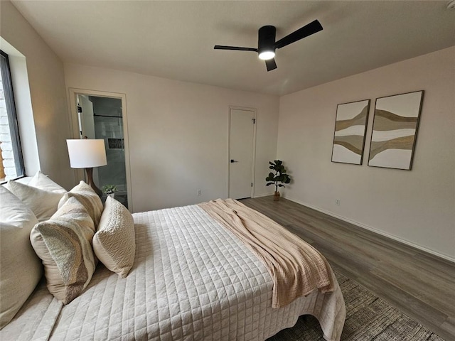 bedroom featuring ceiling fan, baseboards, and wood finished floors