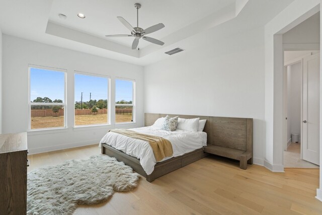 301 Miranda Way, Georgetown, TX 78633 - bedroom with a tray ceiling, light wood-type flooring, recessed lighting, and ceiling fan