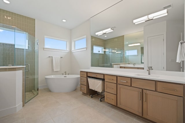 bathroom featuring vanity, plenty of natural light, plus walk in shower, and tile patterned flooring