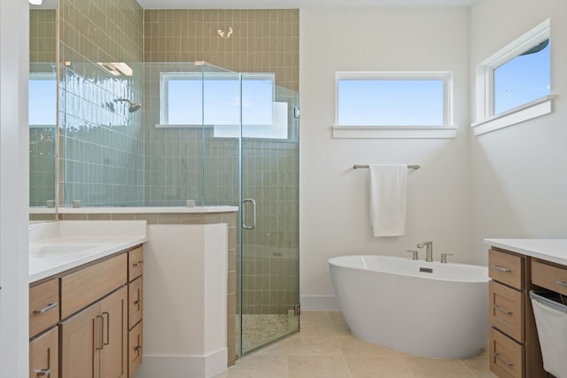 bathroom with vanity, plus walk in shower, and a wealth of natural light