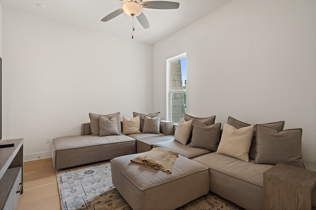 living room with ceiling fan and light wood-type flooring