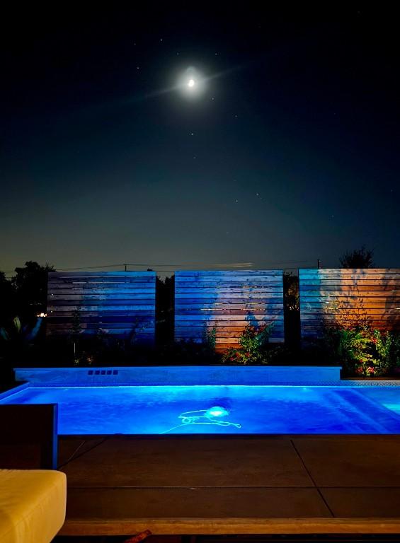 view of pool at night