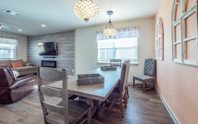 dining room featuring a fireplace, hardwood / wood-style floors, and a wealth of natural light