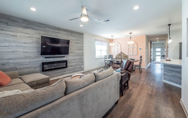 living room with a fireplace, dark hardwood / wood-style floors, and ceiling fan