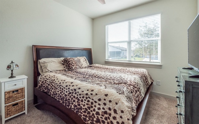 carpeted bedroom with multiple windows and ceiling fan