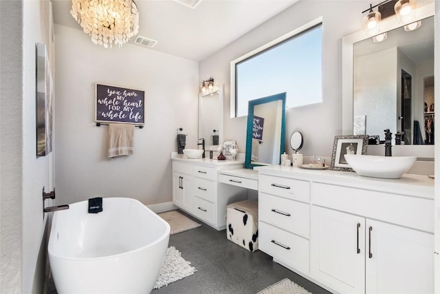 full bathroom with a freestanding tub, visible vents, vanity, and finished concrete floors