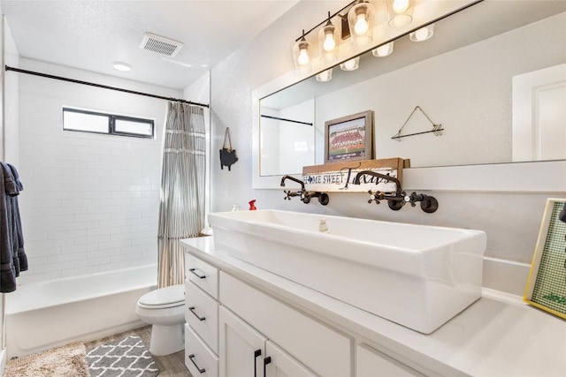 full bath featuring shower / tub combo with curtain, visible vents, vanity, and toilet