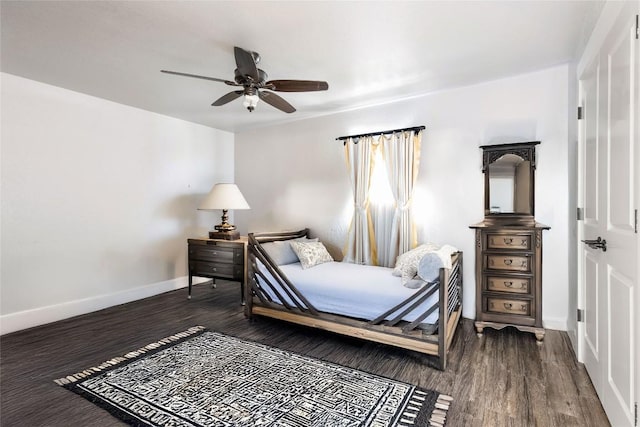 bedroom featuring baseboards, dark wood-style floors, and ceiling fan