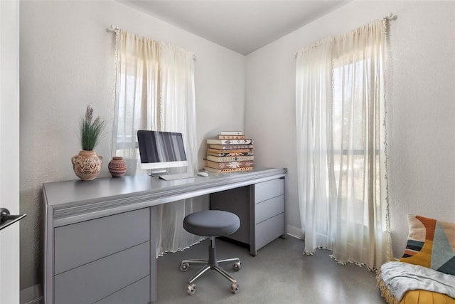home office with finished concrete flooring