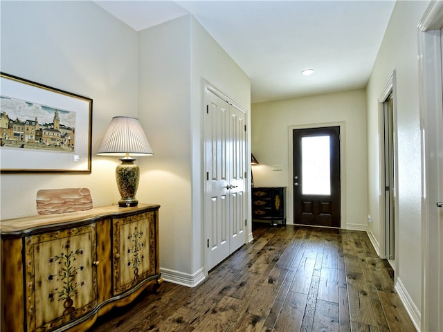 entryway featuring dark wood-style floors and baseboards