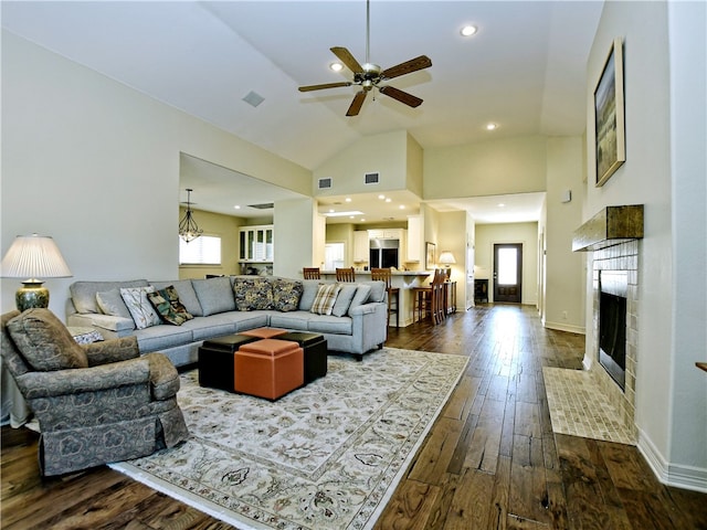 living area featuring dark wood-style floors, a fireplace, high vaulted ceiling, and baseboards