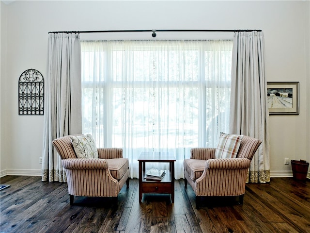 living area with a healthy amount of sunlight and wood finished floors