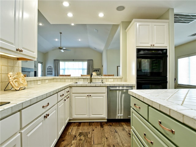 kitchen featuring dishwasher, a sink, dobule oven black, and a healthy amount of sunlight