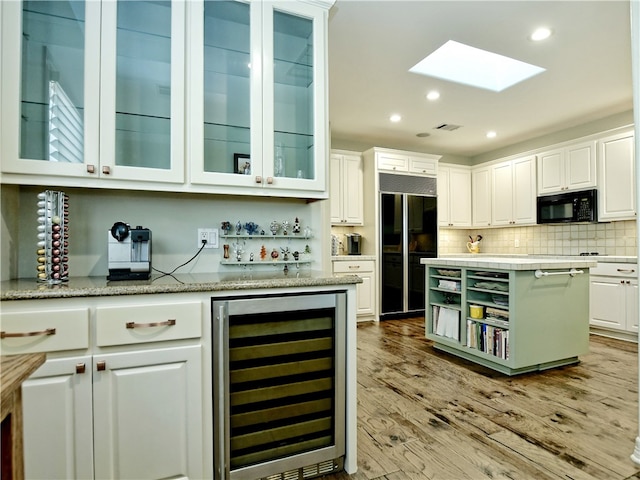 kitchen featuring open shelves, backsplash, white cabinets, beverage cooler, and black appliances