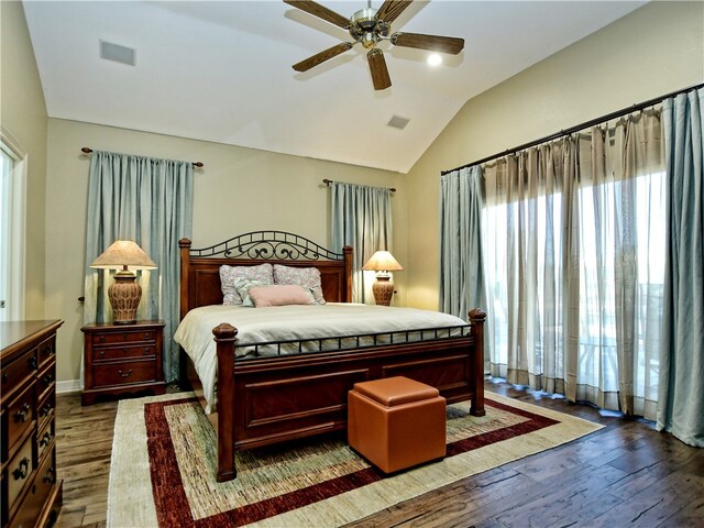 bedroom featuring vaulted ceiling, wood finished floors, visible vents, and a ceiling fan