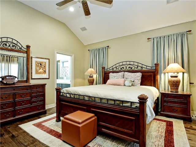 bedroom with visible vents, dark wood finished floors, a ceiling fan, ensuite bath, and vaulted ceiling