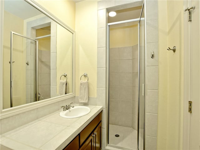 full bath featuring a stall shower and vanity