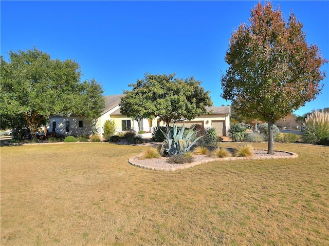 obstructed view of property with a front yard and an attached garage